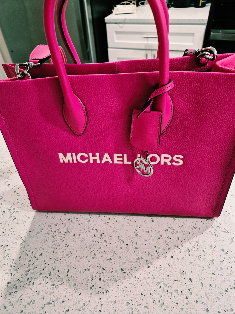 This is a Michael Kors Mirella Medium Tote Bag in a vibrant pink leather